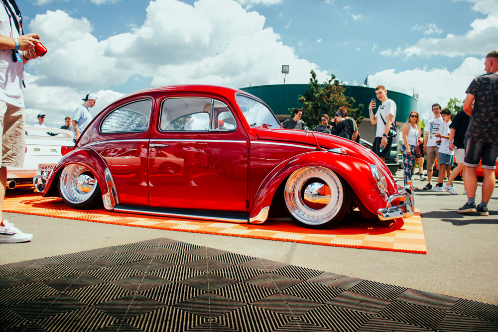 Lowered red classic Volkswagen Beetle on display at a VW show