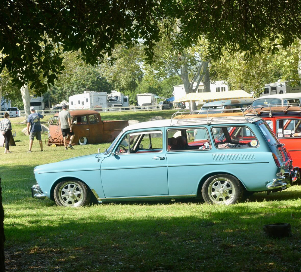 Light blue Volkswagen Type 3 Squareback parked on the grass with other classic VWs at the El Prado VW Show & Shine