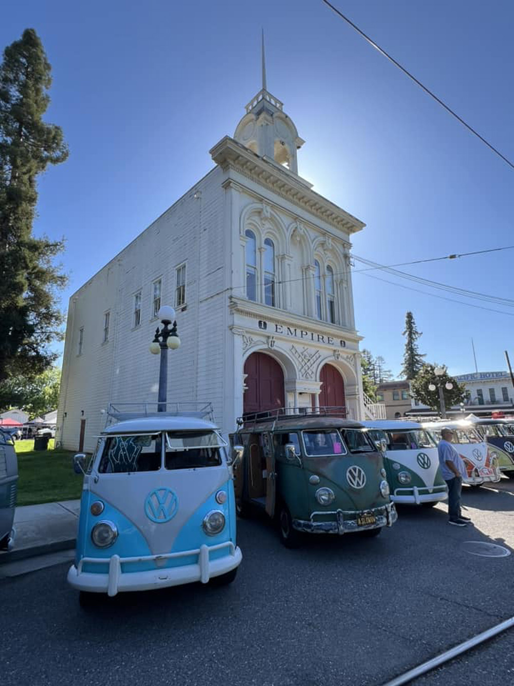 VW Buses in a row in front of a church