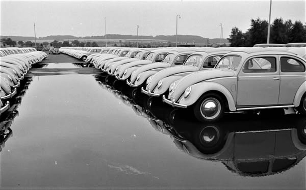 New 
        Volkswagens reflected in standing water