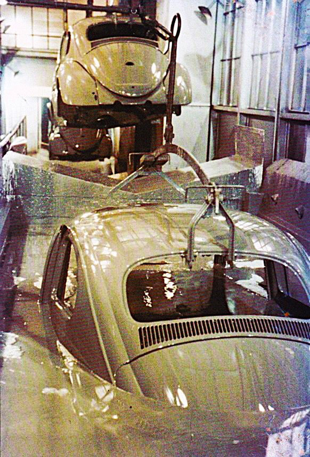 Bodyshells 
        are dipped into a tank of solvent at the Wolfsburg plant