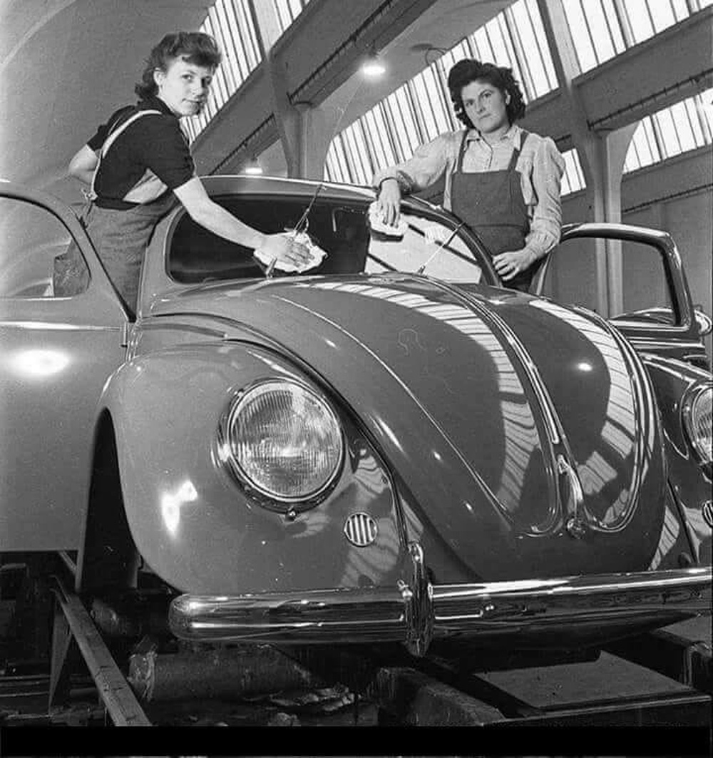 An export Beetle gets a windshield clean on the assembly line at WOB in 1950