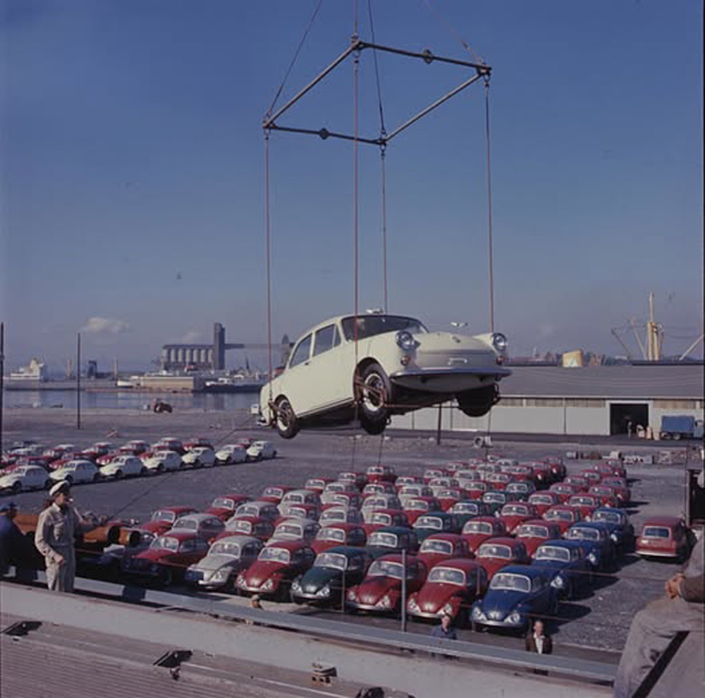 A new VW Type 3 Notchback is hoisted off a cargo ship in Norway