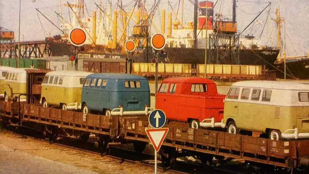 Type 2 combis and a Double-cabin 'Doka' pickup on Deutsche Bundesbahn flatbed wagons arrive at a port in Germany