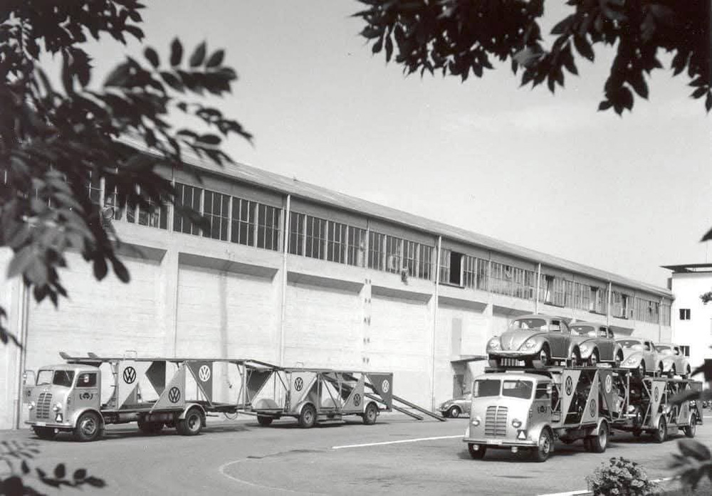 Two Dodge trucks from the Swiss importer AMAG loaded with oval ladybugs in front of the Schinznach-Bad factory 