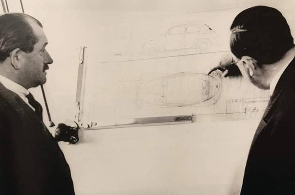 erdinand 
        Porsche and Karl Rabe studying a blueprint